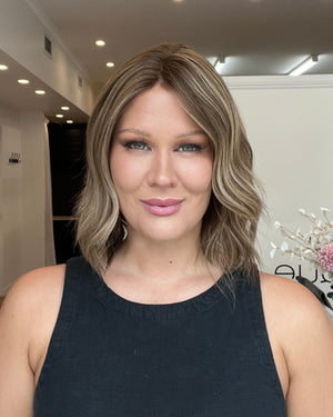 Woman with shoulder-length hair in a salon setting