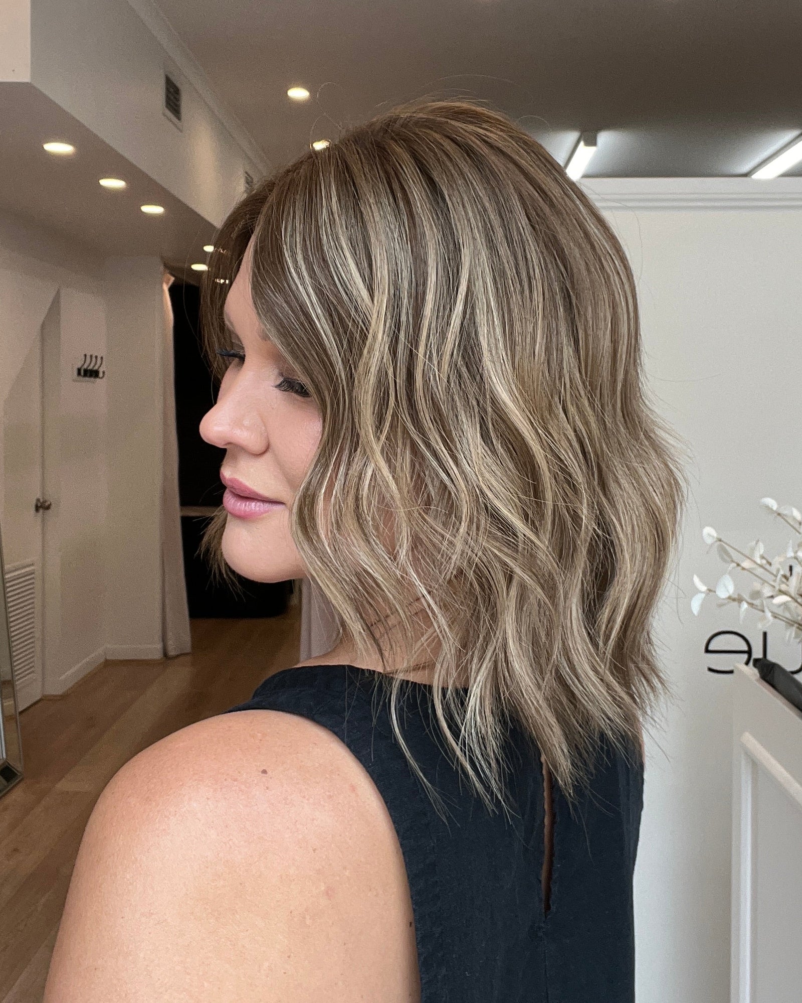 Woman with shoulder-length hair in a salon setting