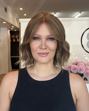Woman with a floral arrangement in an indoor setting