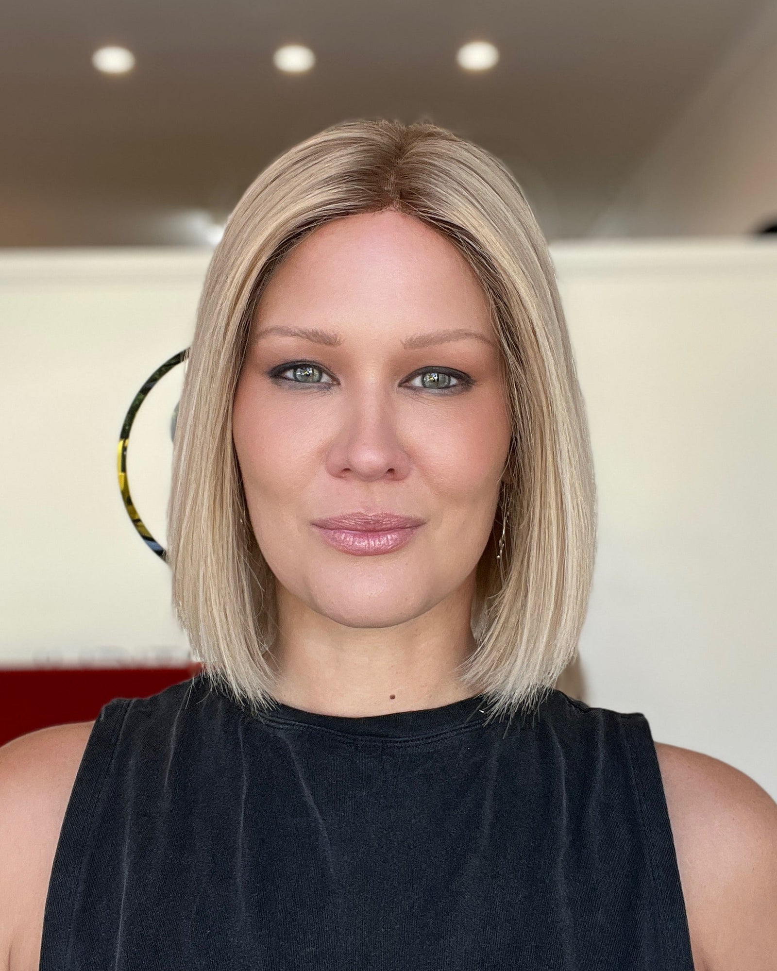 Woman with a short blonde bob haircut in an indoor setting