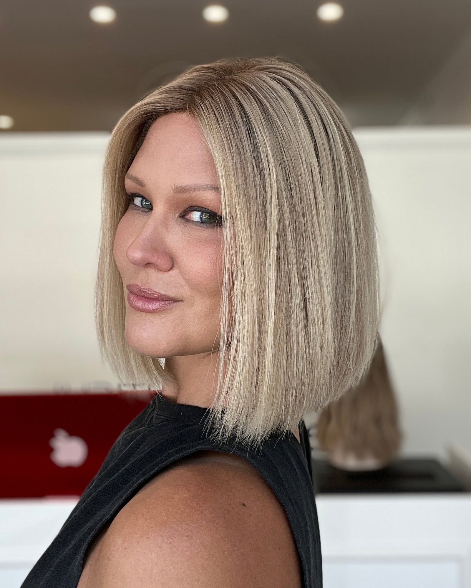 Woman with a short blonde bob haircut in an indoor setting