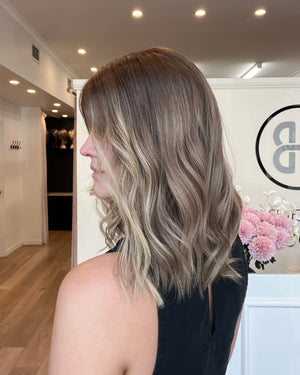 Woman with styled hair in a salon setting