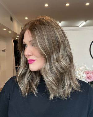Woman with styled hair in a salon setting