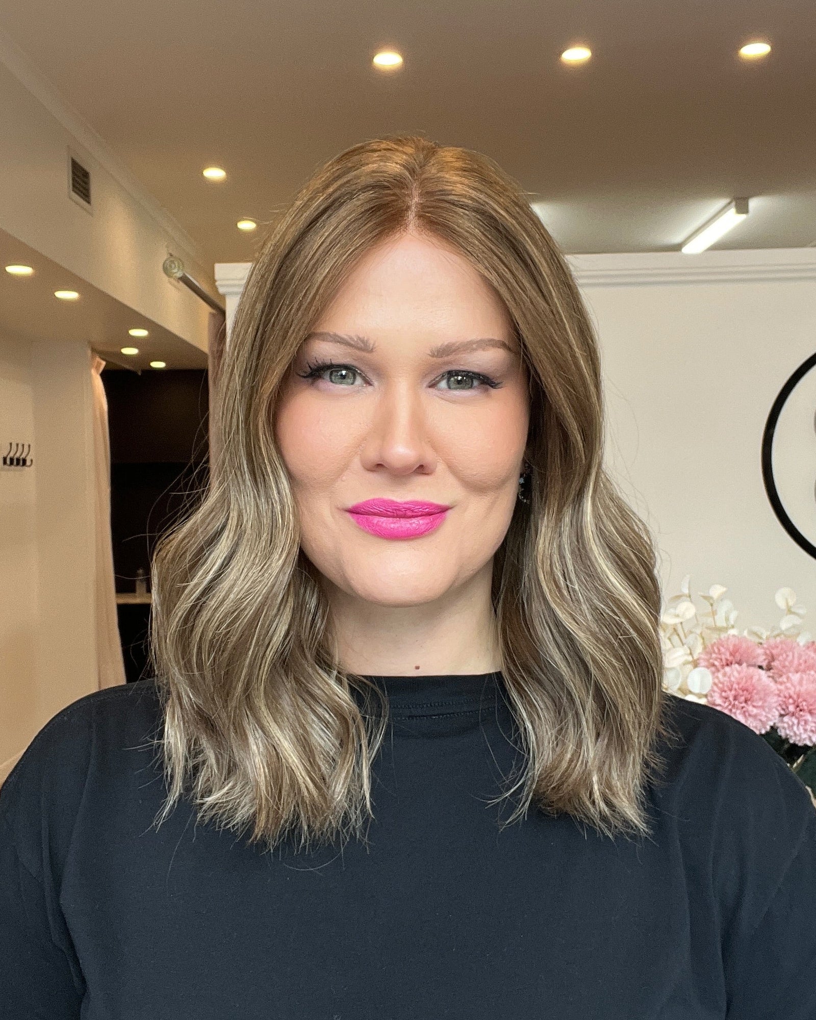 Woman with 16 inch medium brown wavy wig.