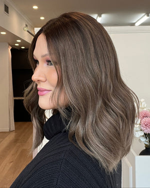 Woman with styled hair in a salon setting