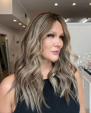 Woman with styled hair in a salon setting
