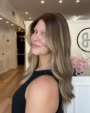 Woman with long, wavy hair in a salon setting