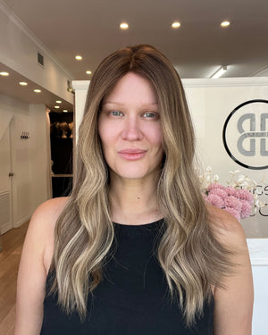 Woman with long, wavy hair in a salon setting