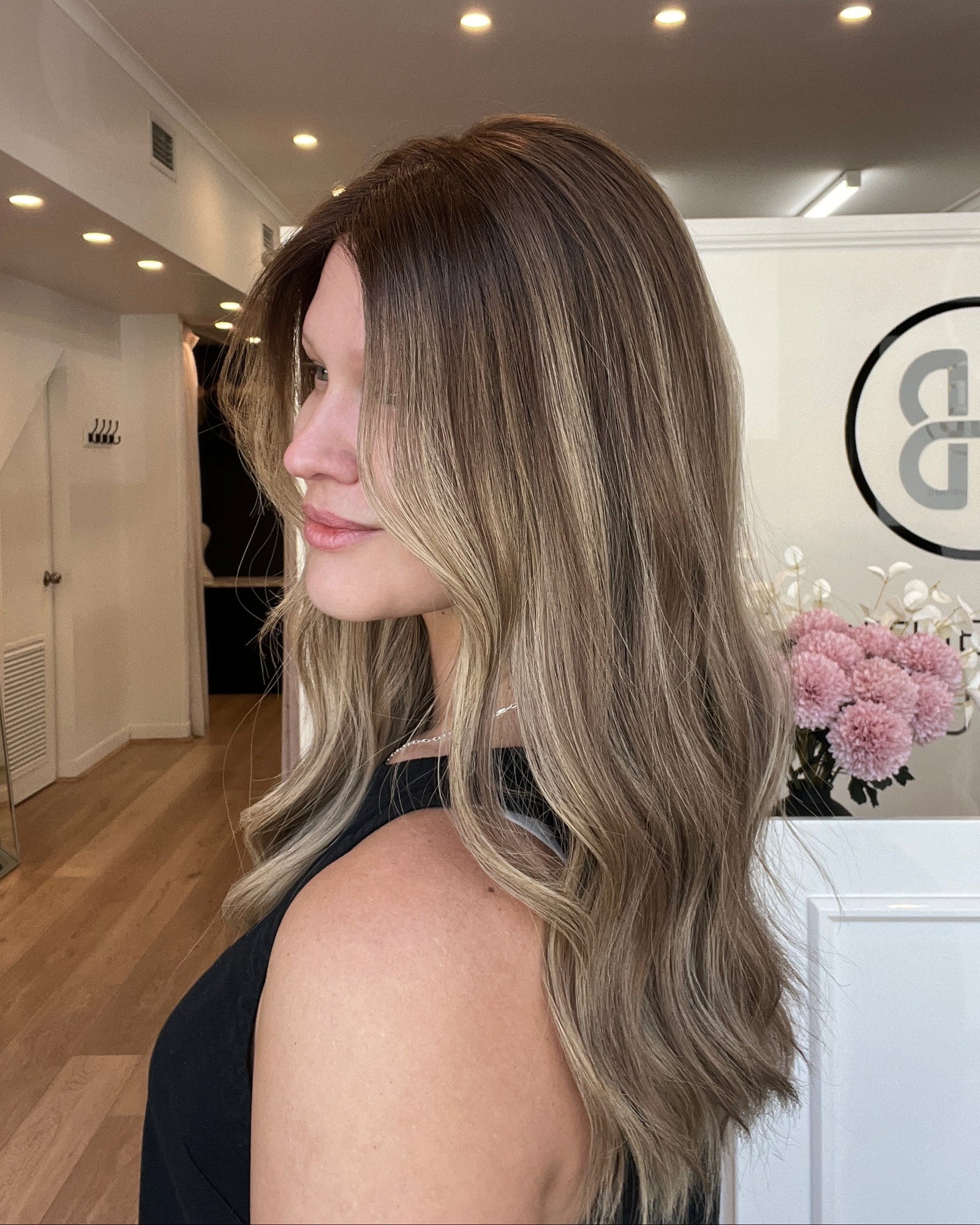 Woman with long, wavy hair in a salon setting